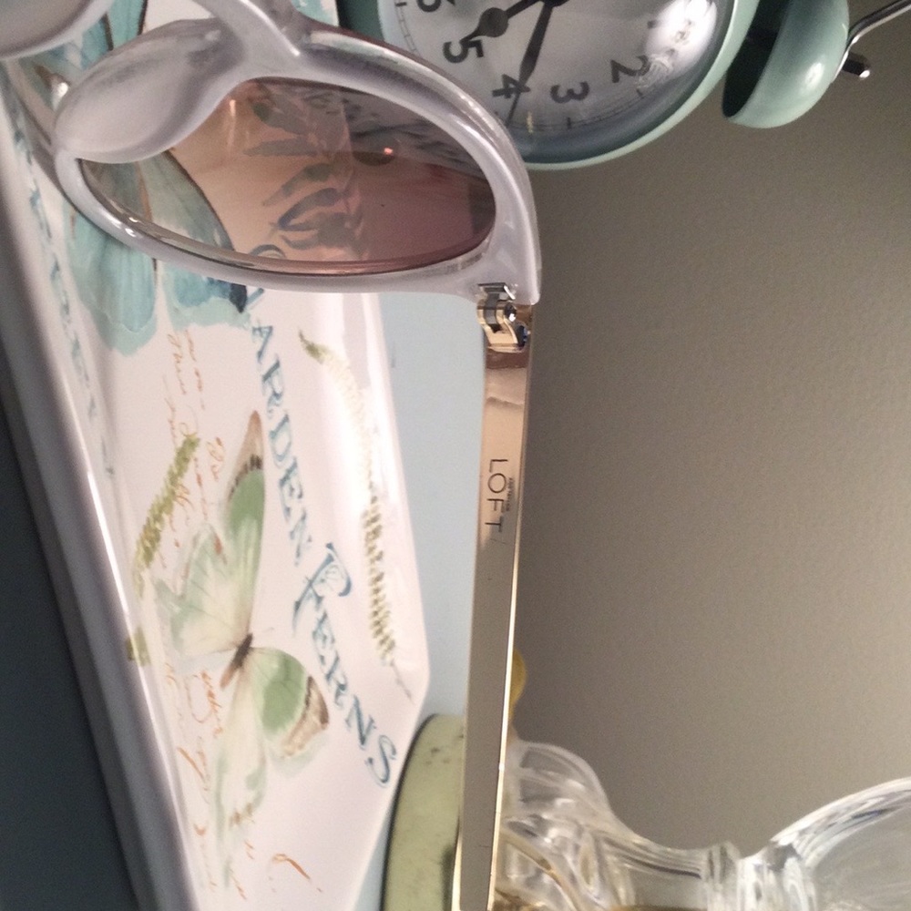 Loft sunglasses with frosted white frames and gold accents.